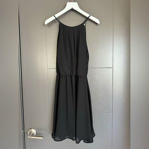 Lush sleeveless black open-back dress with flowy A-line skirt